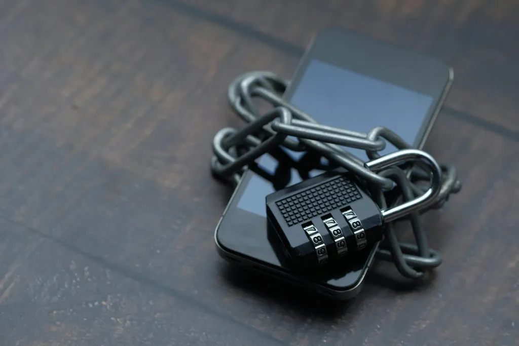 A combination lock and chain wrapped around a smartphone
